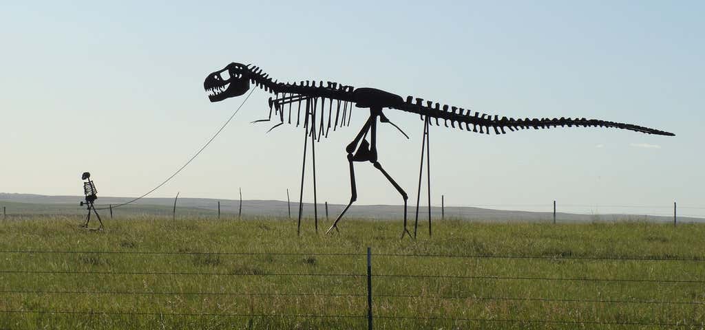 Photo of Statue of Man Walking Dino