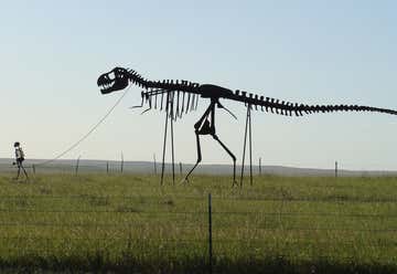 Photo of Statue of Man Walking Dino